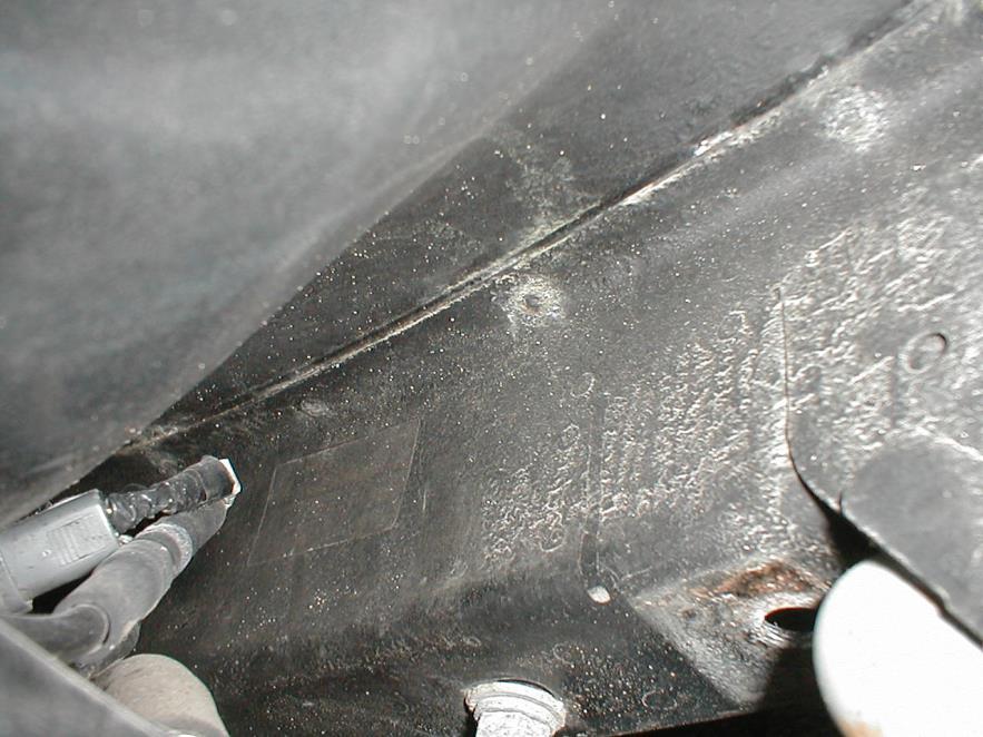Arrow points to top side of trunk floor where frame rail is welded to underside Poor quality and insufficient welds