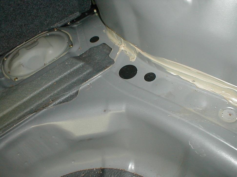 Exact undamaged vehicle trunk floor. Arrows correspond to poorly repaired photo on right.