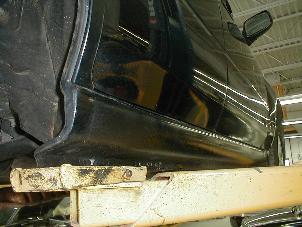 Rusted and poor welds between outer quarter panel and