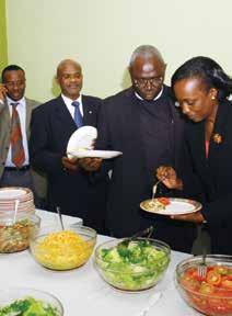 Dr. Ruth Ssenyonyi (Extreme right), and other participants serving their meal