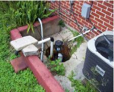 Figure 3-4: Rain water and seepage under this floodwall collect in the basin, or sump, and is pumped over the wall by a sump pump. Soil permeability is a flooding concern.