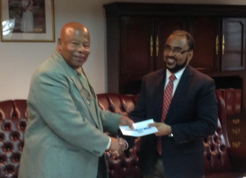 Mr. Isaac Anthony, CEO, CCRIF SPC (right) presents a cheque for US$0.5M to Anguilla s Chief Minister Hon. Hubert Hughes (left) on October 29, 2014.