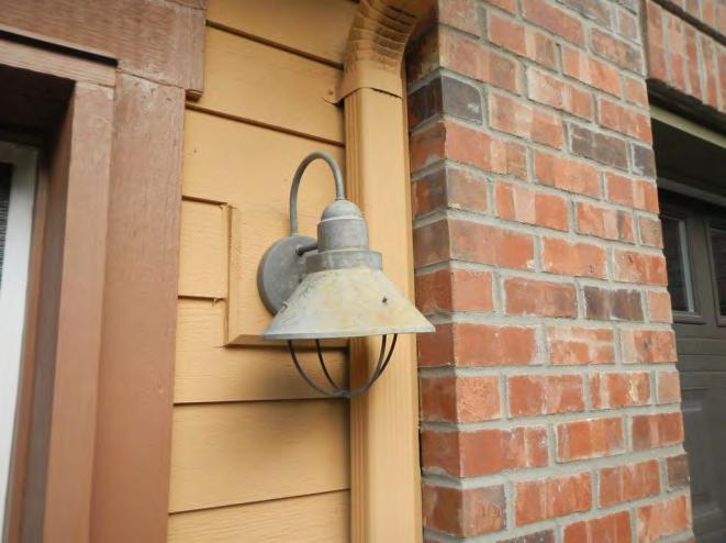 The exterior light fixtures consist of one building mounted light at the front of each individual unit and one building mounted light above the doors at the rear of each individual unit.