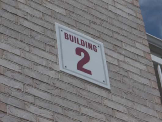 Source of Information: The building and unit signs are in good to fair condition.