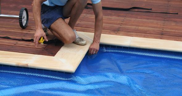 Unroll the pool cover and then place the cover over the surface of the pool with the bubble side facing downwards.