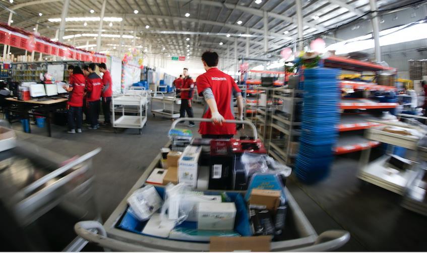 com warehouse employees prepare same-day delivery Unlike competitor Alibaba, JD.