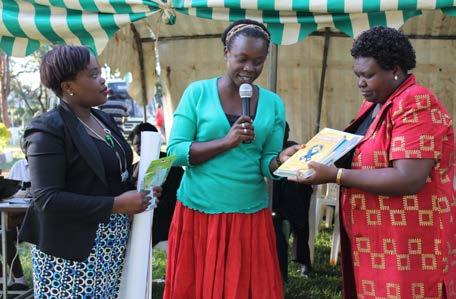 State House Girls principal receives book donation from PR Manager, Diana Olenja, as