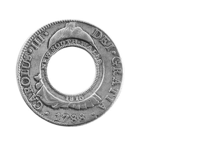 THE HOLEY DOLLAR In 1813 Governor Lachlan Macquarie overcame an acute currency shortage by purchasing Spanish silver dollars (then worth five shillings), punching the centres out and creating two