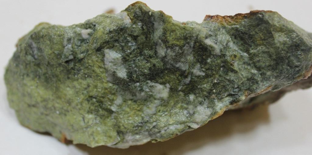 Alteration is mainly silicacarbonatechloritesericite which alters the grey host rocks to variable greenish colours (Figures 67).