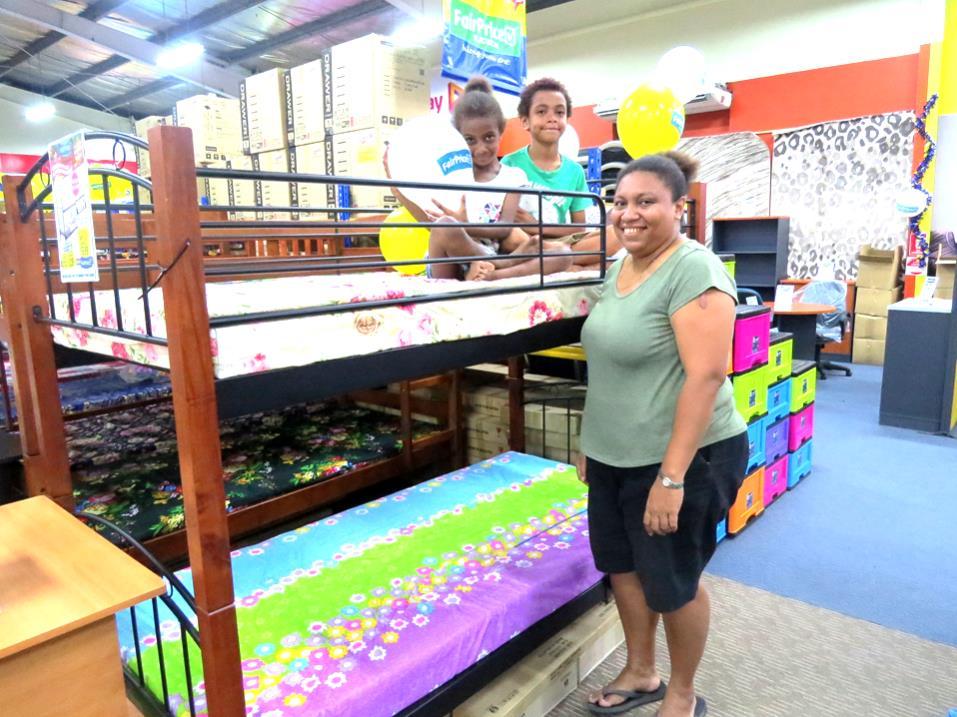 This opportunity came along when NCSL Moresby: NCSL member Sylvie Rupa Ikufu with children at FairPrice Showroom after her loan was approved to purchase goods under NCSL s new Credit Facility.