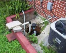 Figure 7: Rain water and seepage under this floodwall collect in the basin, or sump, and is pumped over the wall by a sump pump. Soil permeability is a flooding concern.