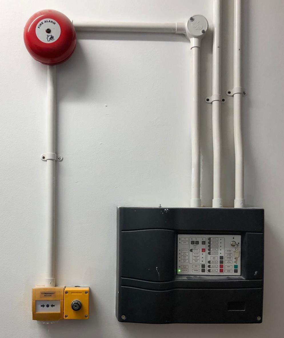 Images of existing gas fire suppression system: Figure 1. Control panel for gas suppression system on outside wall of server room.
