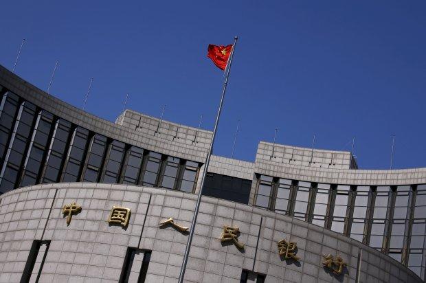 China s central bank on Friday also cut the reserve-requirement ratio for banks by 0.5 percentage point. Above, the People's Bank of China headquarters in Beijing.