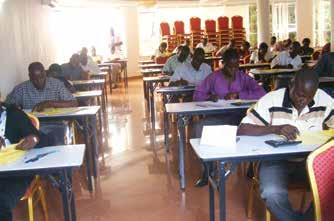 1.Some students writing their examinations at the Gulu