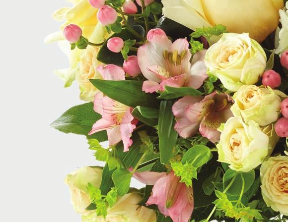 Luscious florals are placed in a clear vase with a hammered gold metallic base, making this arrangement a favorite