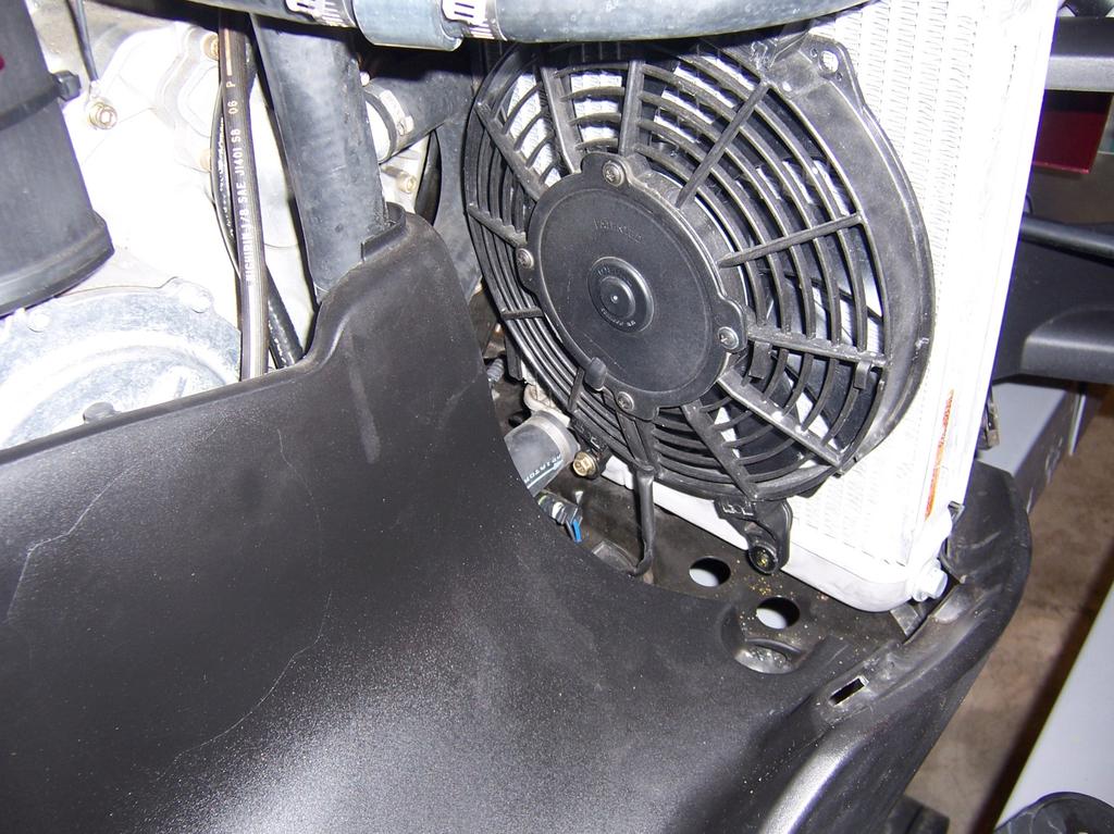 4. Loosen the lower outer bolt that holds the radiator fan to the radiator.